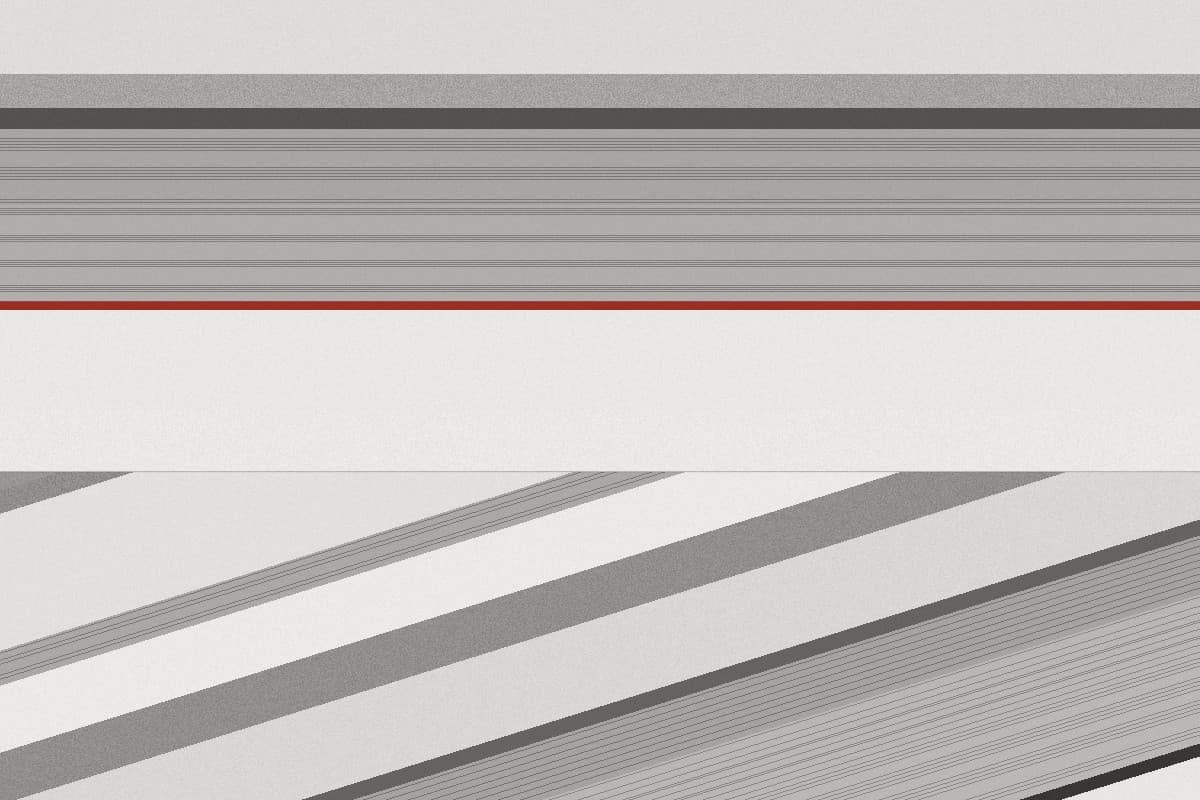 Horizontal gray strata pressed into fine bands, crossed lower down by diagonal layers, with one thin red seam